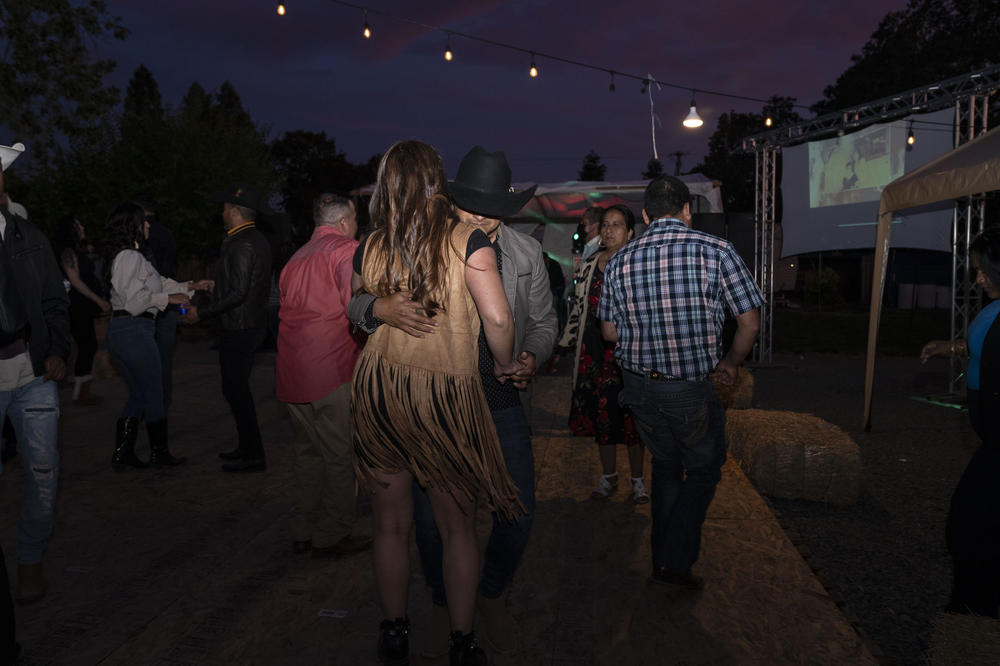 People dance at Kevin's 18th birthday party. Kevin gathered as many Michoacanos as he could invite in his community in California, many of whom were from the same small avocado-producing town his family had fled after organized crime took control.