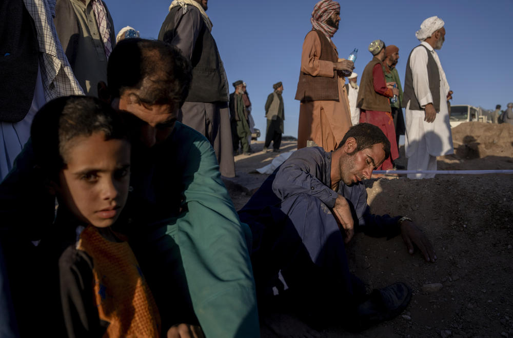 Mon., Oct. 9: An Afghan man mourns next to the grave of his wife who died due to an earthquake, in Zenda Jan district in Herat.