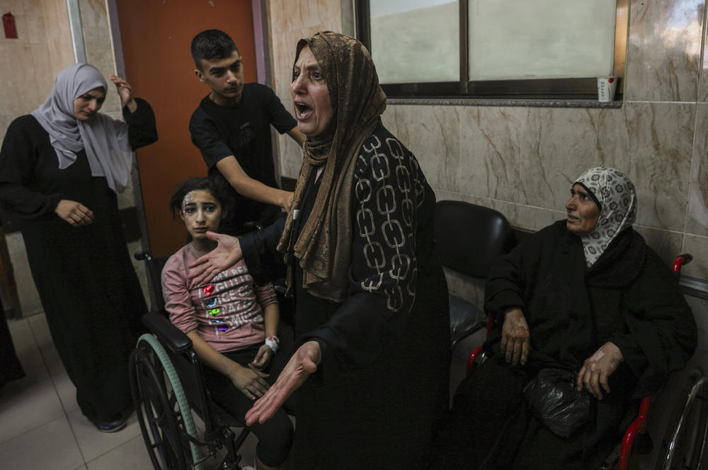 Sun., Oct. 15: A Palestinian woman reacts next to people wounded in an Israeli airstrike, at al-Aqsa Hospital in Deir el-Balah, central Gaza Strip.
