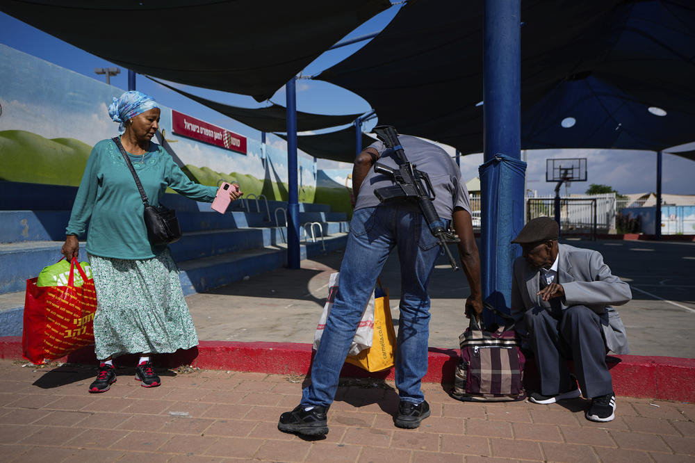 Sun., Oct. 15: Israelis carry their belongings as they evacuate from the southern Israeli town of Sderot, located near the border with the Gaza Strip.