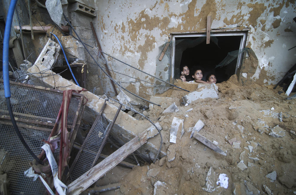 Sat., Oct. 14: Palestinian children look at the building of the Zanon family, destroyed in Israeli airstrikes in Rafah, Gaza Strip.