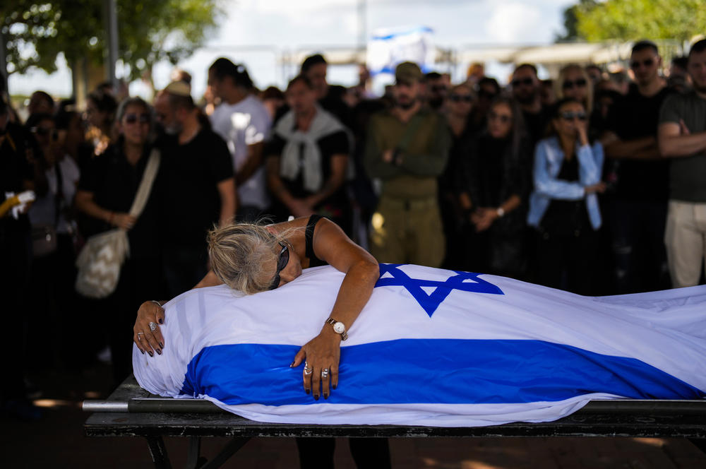 Sun., Oct. 15: Antonio Macías' mother cries over her son's body, covered with the Israeli flag, at Pardes Haim cemetery in Kfar Saba, Israel.