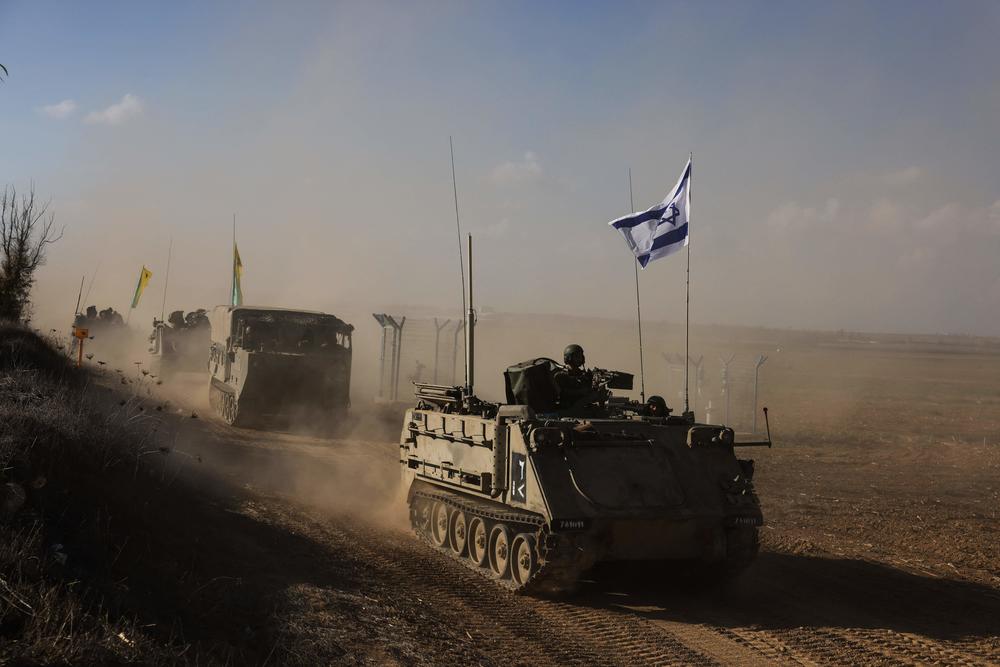 Sun., Oct. 15: A convoy of Israeli military vehicles drives down a road at an undisclosed location on the border with the Gaza Strip.