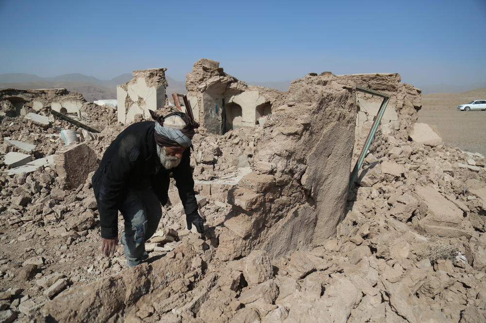 A man walks on rubbles after the 6.3 magnitude earthquake struck Afghanistan's western province of Herat on October 15, 2023.