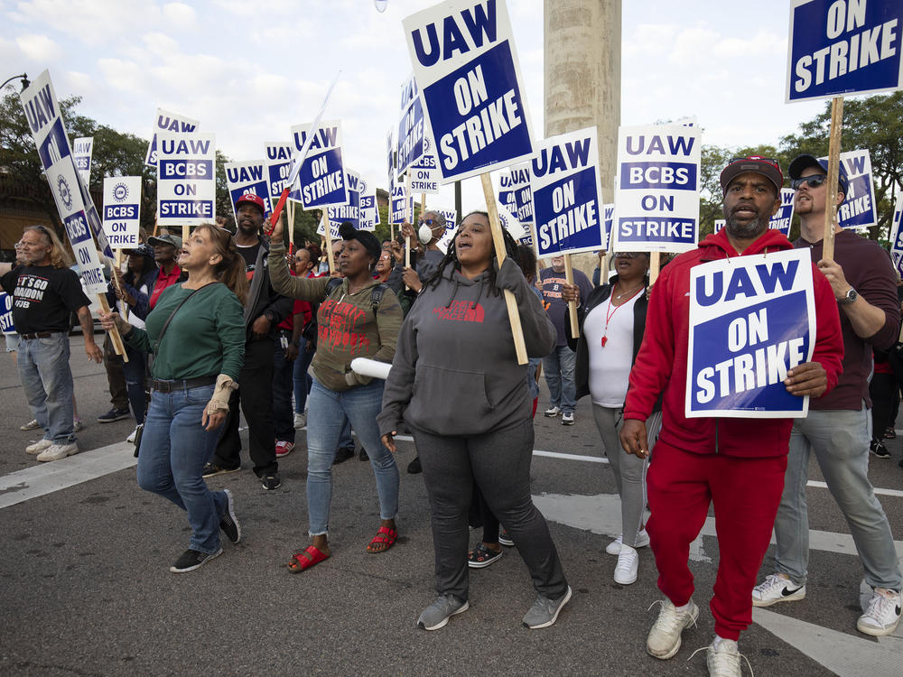 Striking Blue Cross Blue Shield workers show their support for UAW members at a march through downtown Detroit on Sept. 15.