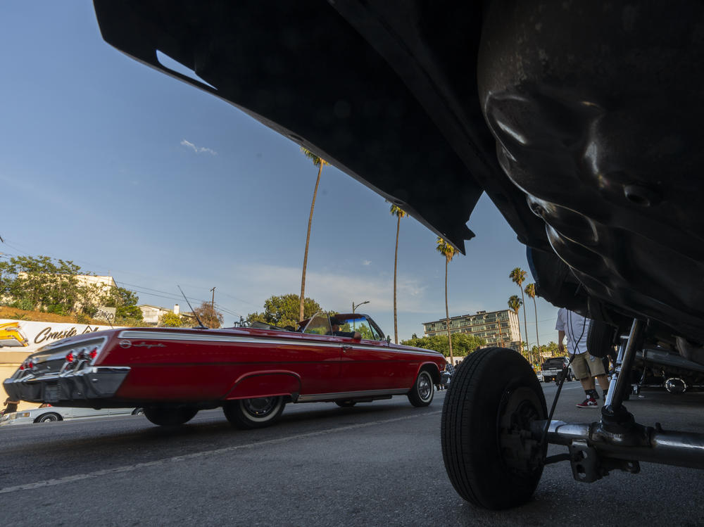 A convertible Lowrider vehicle cruises on Sunset Blvd., in the Echo Park neighborhood of Los Angeles late Sunday afternoon July 18, 2021.