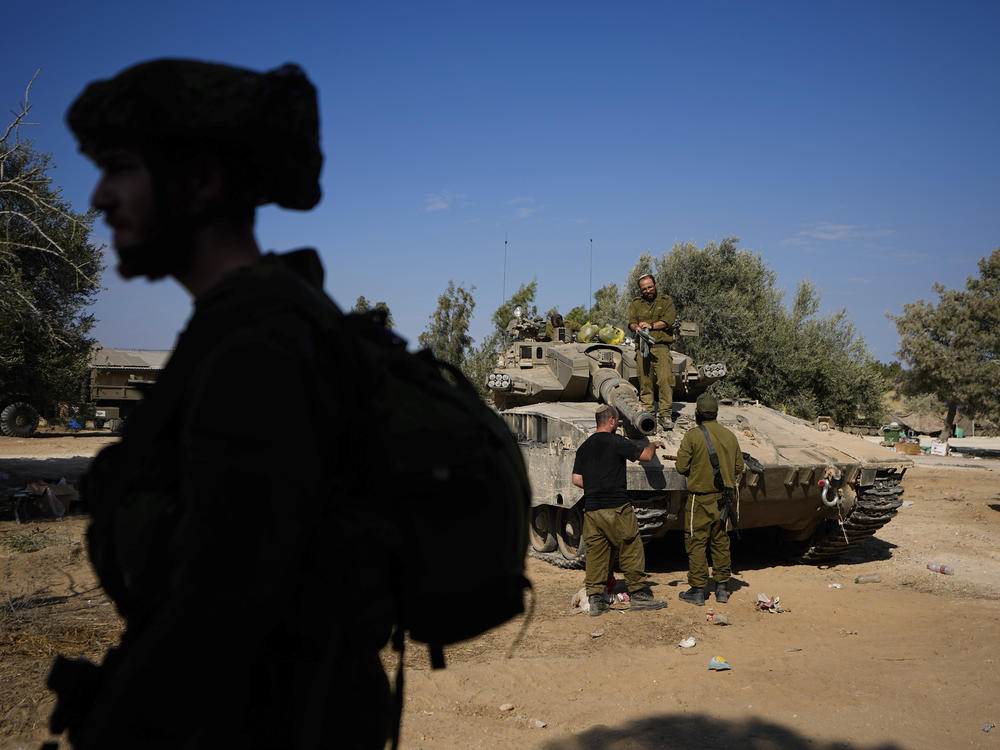 Israeli soldiers gather in a staging area near the border with Gaza Strip, in southern Israel Tuesday.