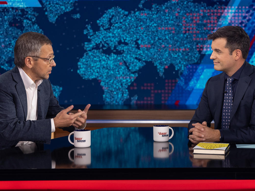 Author and political scientist Ian Bremmer, left, speaks with <em>The Daily Show</em> guest host Michael Kosta.