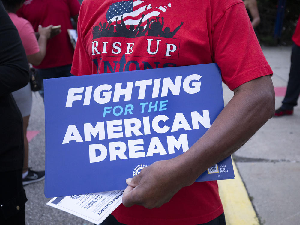 Stellantis workers attend an event in July with United Auto Workers President Shawn Fain to mark the beginning of the UAW's contract talks with Stellantis at the assembly plant in Sterling Heights, Mich.