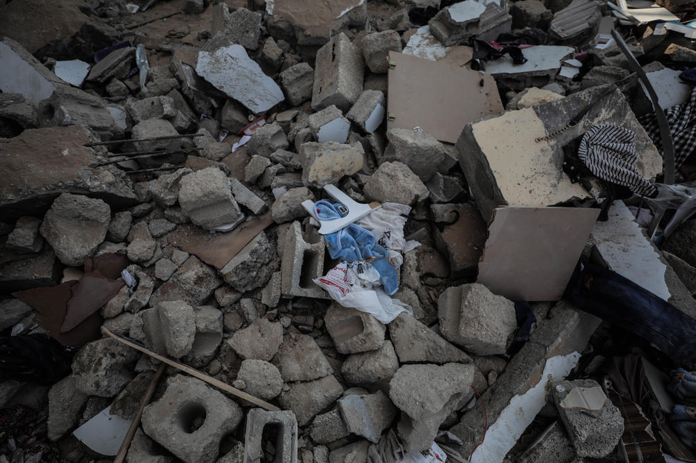 Children's clothes are seen in the rubble after an Israeli bombing on a house in the city of Khan Yunis in southern Gaza on October 16.