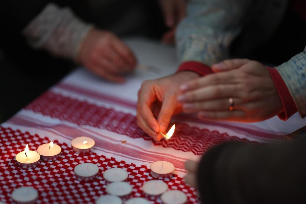 Members of the Chicago area Jewish community gather to publicly recite the kaddish and light candles to mourn the Palestinians and Israelis killed during recent fighting.