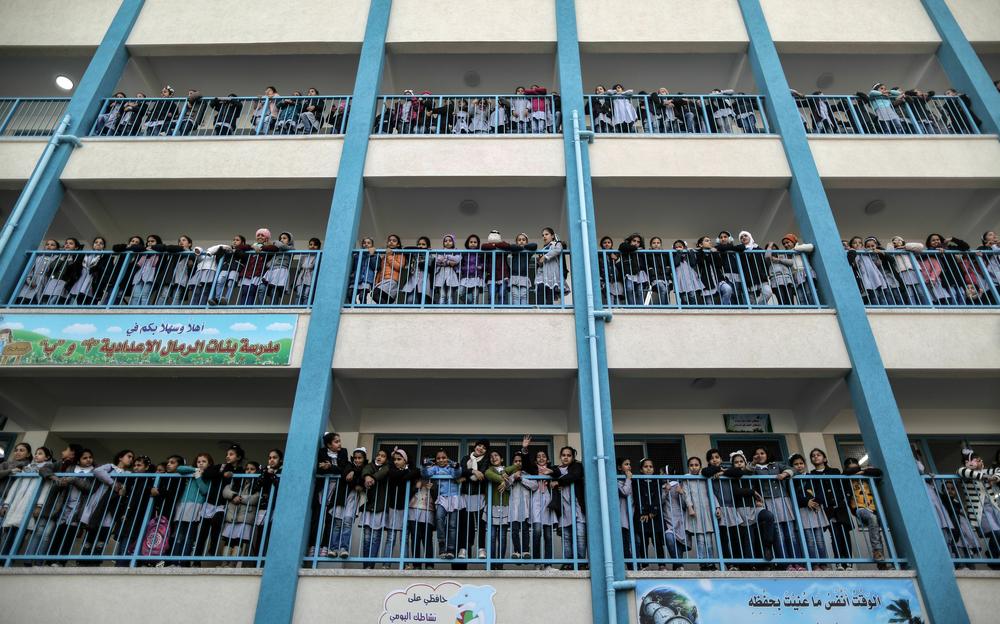 Schoolgirls pose for a group picture outside their classrooms at a school in Gaza City in January 2018.