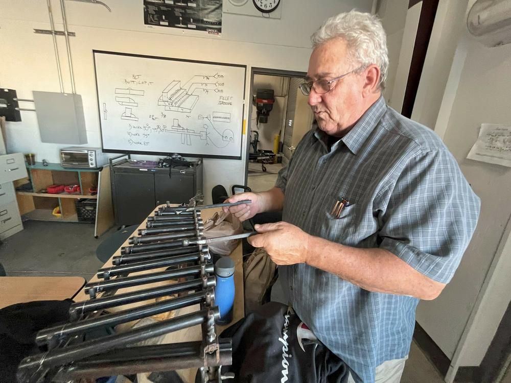 RFK Charter School Director Robert Baade picks out a tune on a xylophone that his students made from gun barrels.