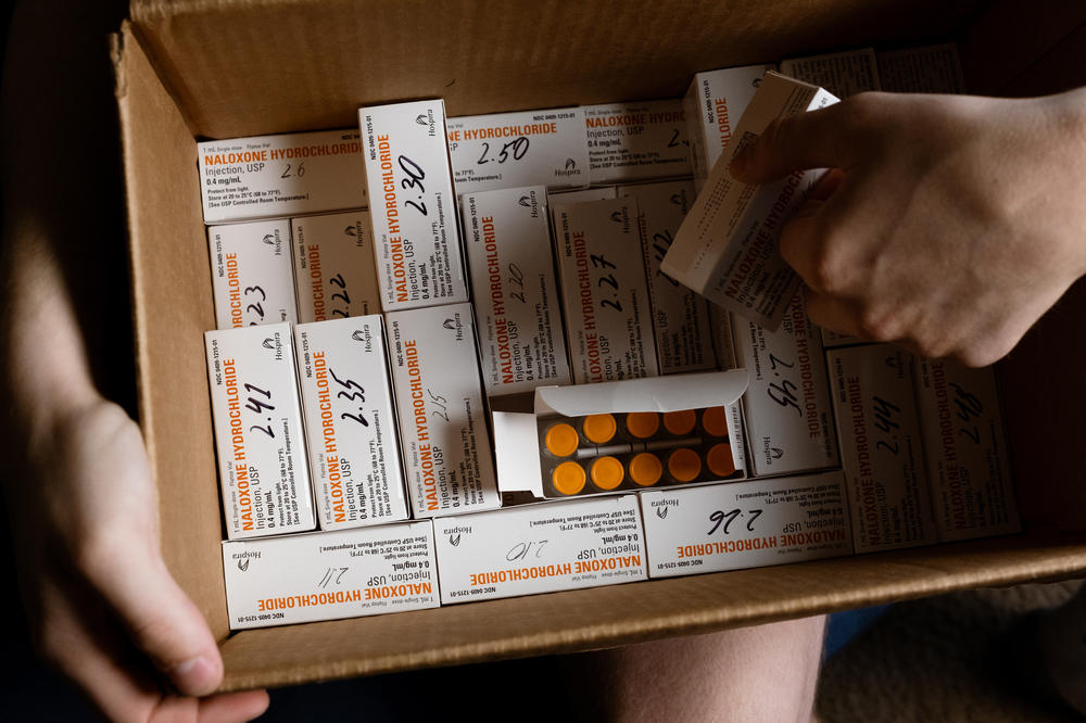 UNC student Riley Sullivan holds a box of naloxone vials that he stores in his apartment for harm-reduction tabling events. Naloxone can reverse an opioid overdose.