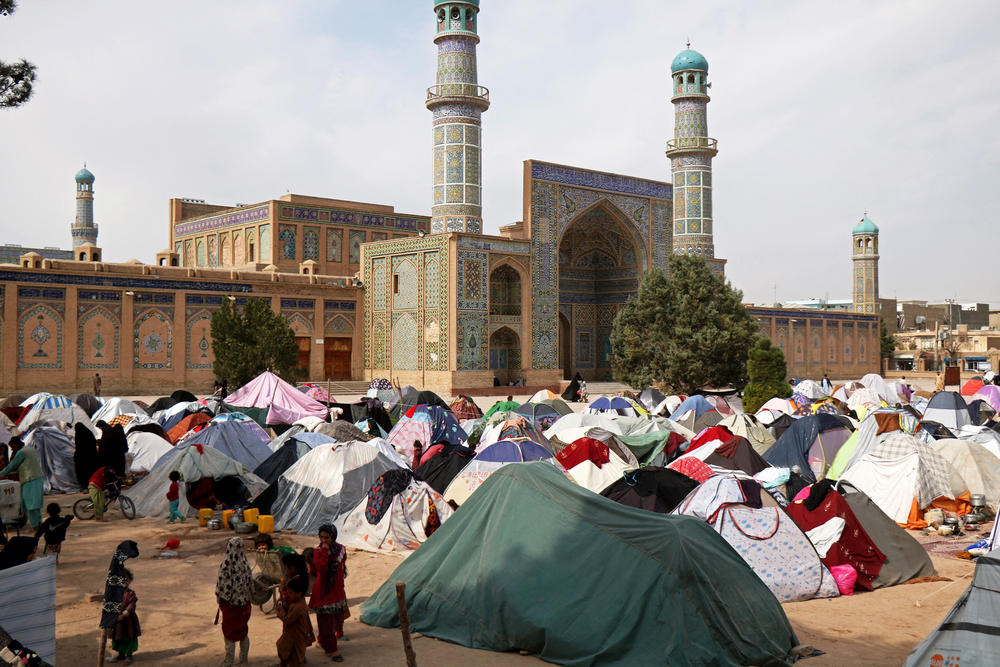 Children walk past makeshift shelters in front of the Jami Mosque in Herat just two days after a magnitude 6.3 earthquake in western Afghanistan on Oct. 15.