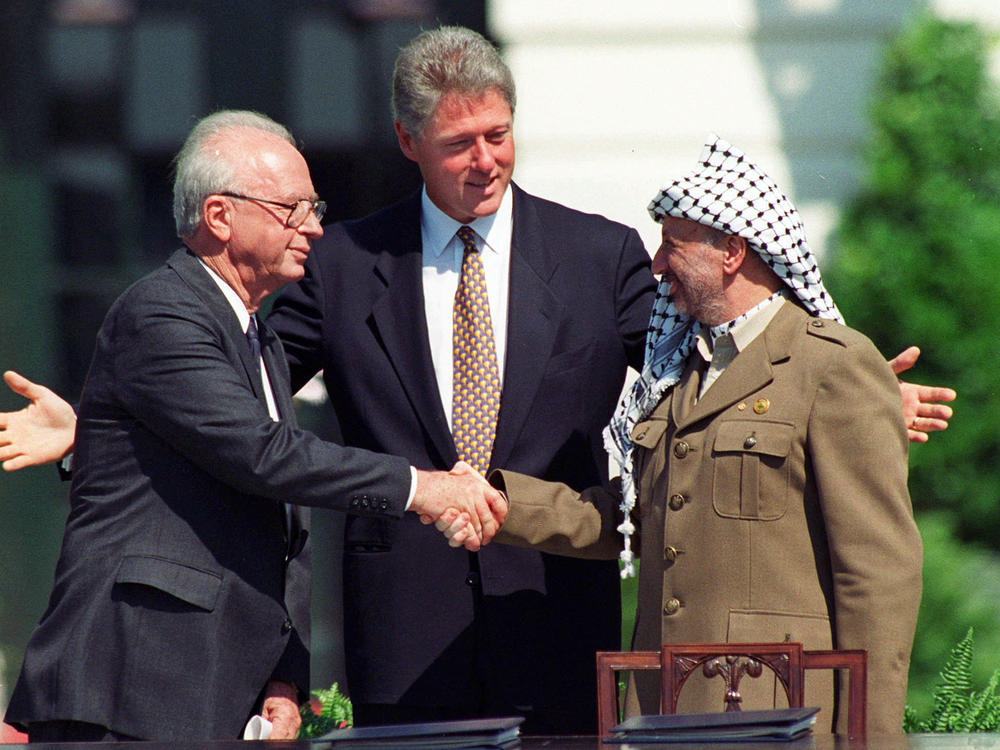 In this Sept. 13, 1993 file photo, President Clinton presides over White House ceremonies marking the signing of the peace accord between Israel and the Palestinians with Israeli Prime Minister Yitzhak Rabin, left, and Palestinian leader Yasser Arafat, right, in Washington.