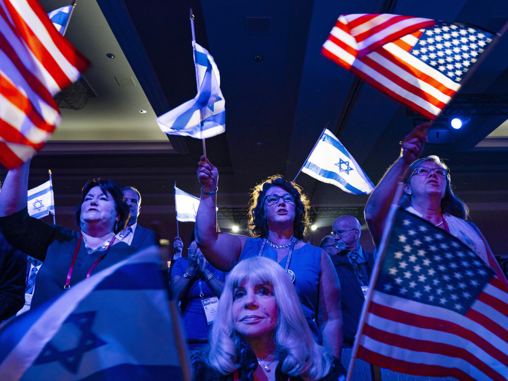 A crowd of mostly Evangelical Christians waves U.S. and Israeli flags during the Christians United For Israel (CUFI) 