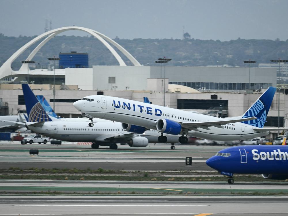A United Airlines Boeing 737 airplane passes a Southwest Airlines jet while taking off from Los Angeles International Airport on September 11, 2023.