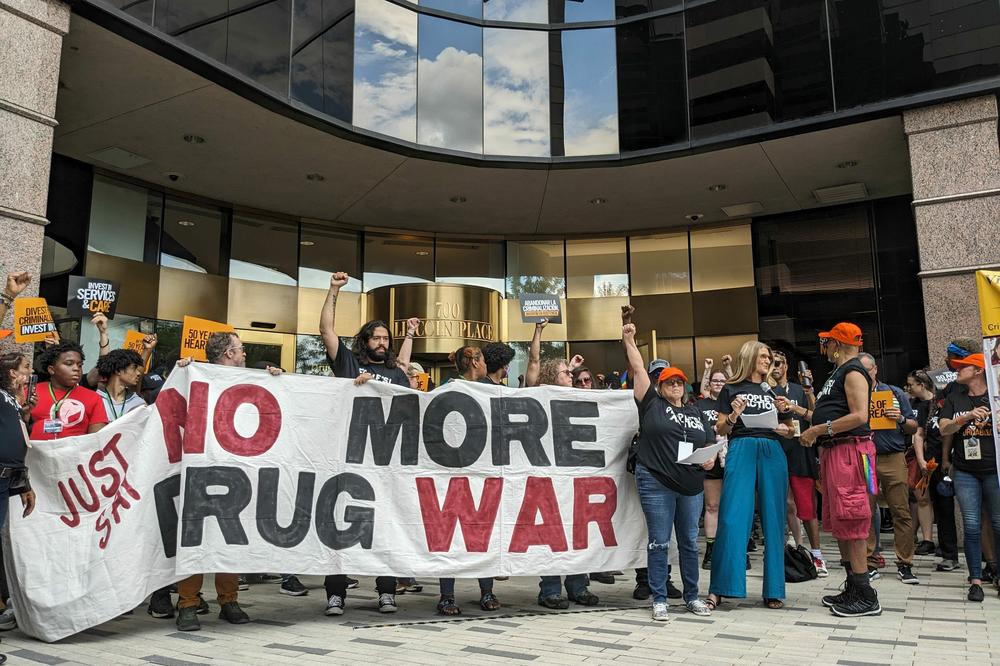 Members of People's Action, a national advocacy organization representing working and poor people, gather outside the Drug Enforcement Administration headquarters in Washington, D.C., on June 27 to call for an end to a criminal justice approach to addiction — pushing instead for investments in health care and housing.
