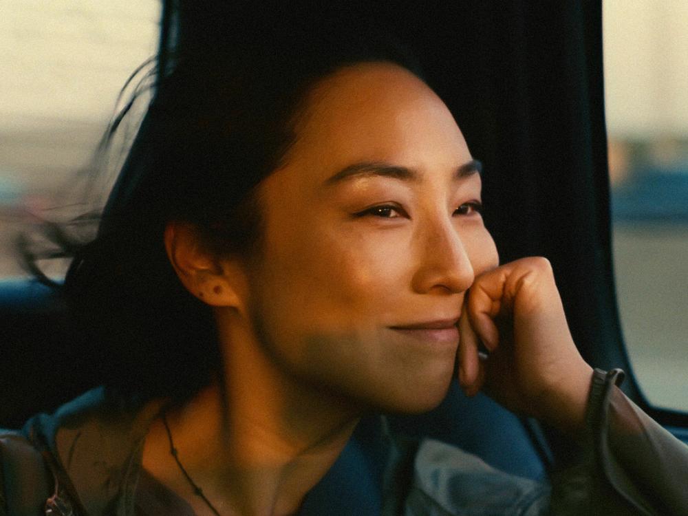 Greta Lee stars as a playwright caught between her American husband and her Korean childhood sweetheart in <em>Past Lives.</em>