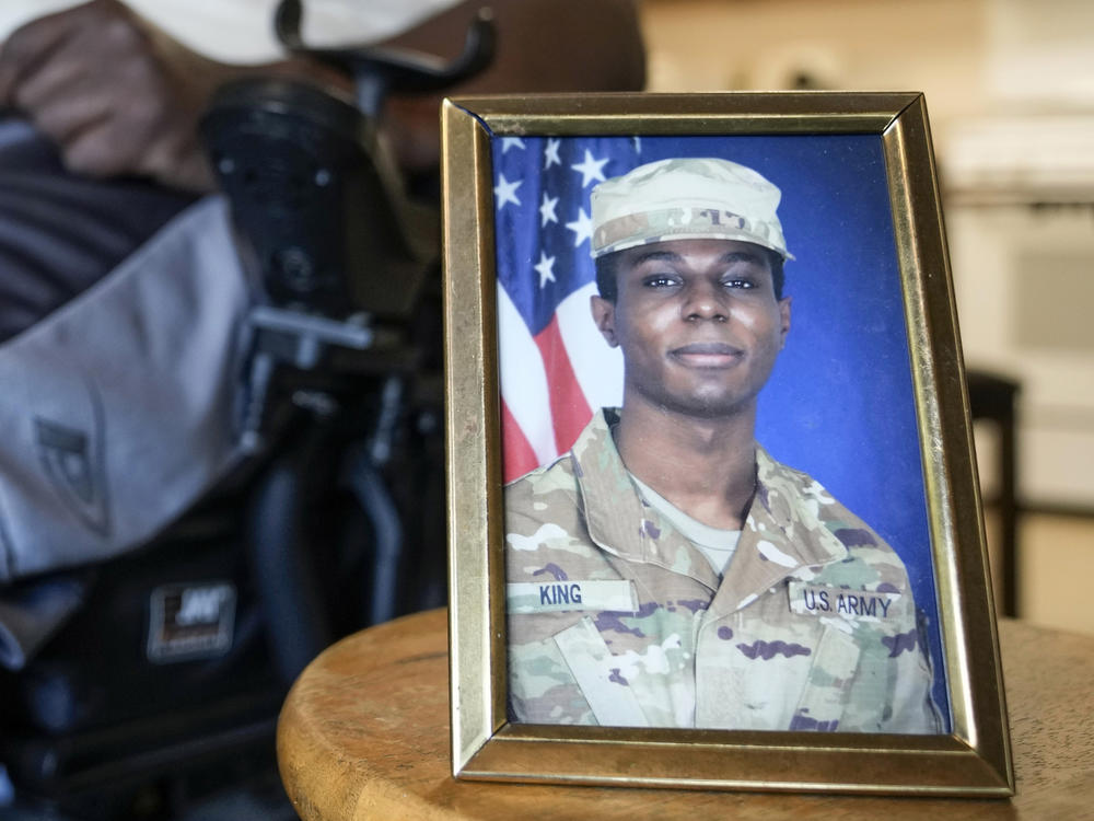 A portrait of Army Pvt. Travis King is displayed as his grandfather, Carl Gates, talks about his grandson on July 19, 2023, in Kenosha, Wis.