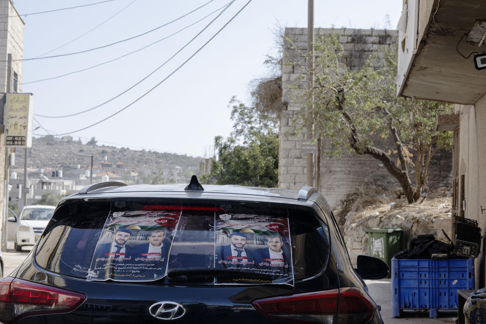 Posters of those killed adorn walls and doors of community.