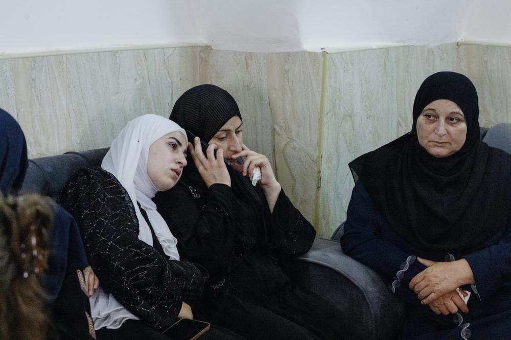 Women gather and mourn at the wake for men killed in Qusra.