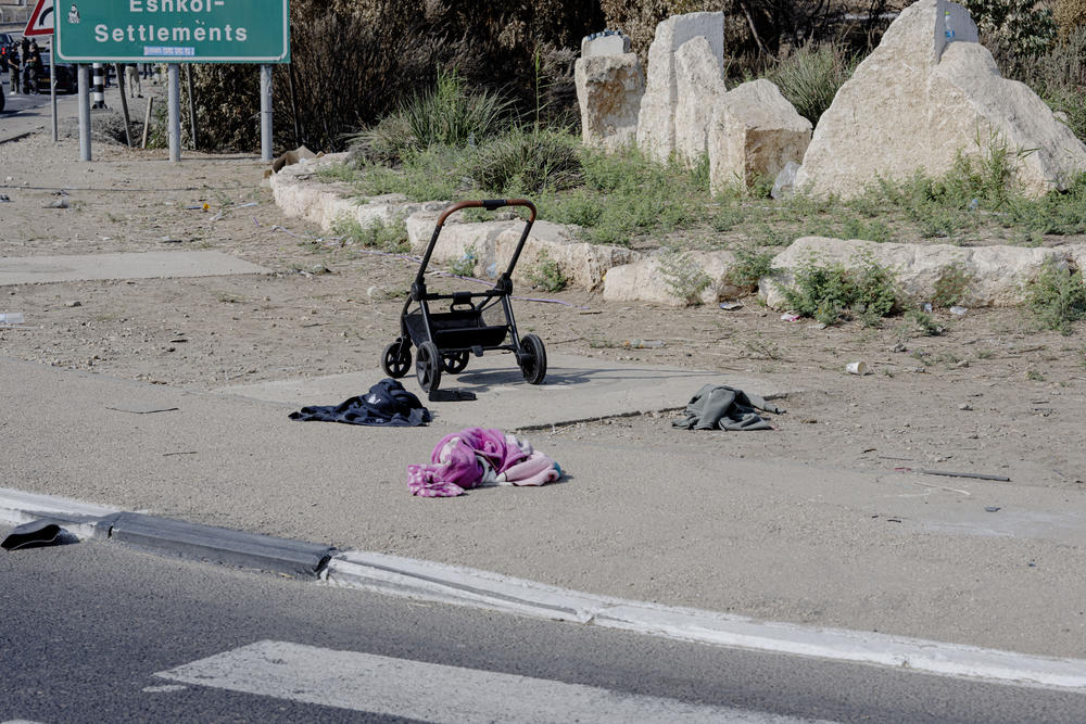 An abandoned stroller and blanket on the road passing the city of Sderot.