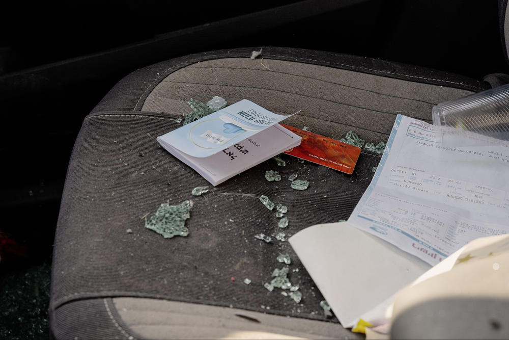 A car with glass inside and bullet holes. The police did not know what happened to the people in car.