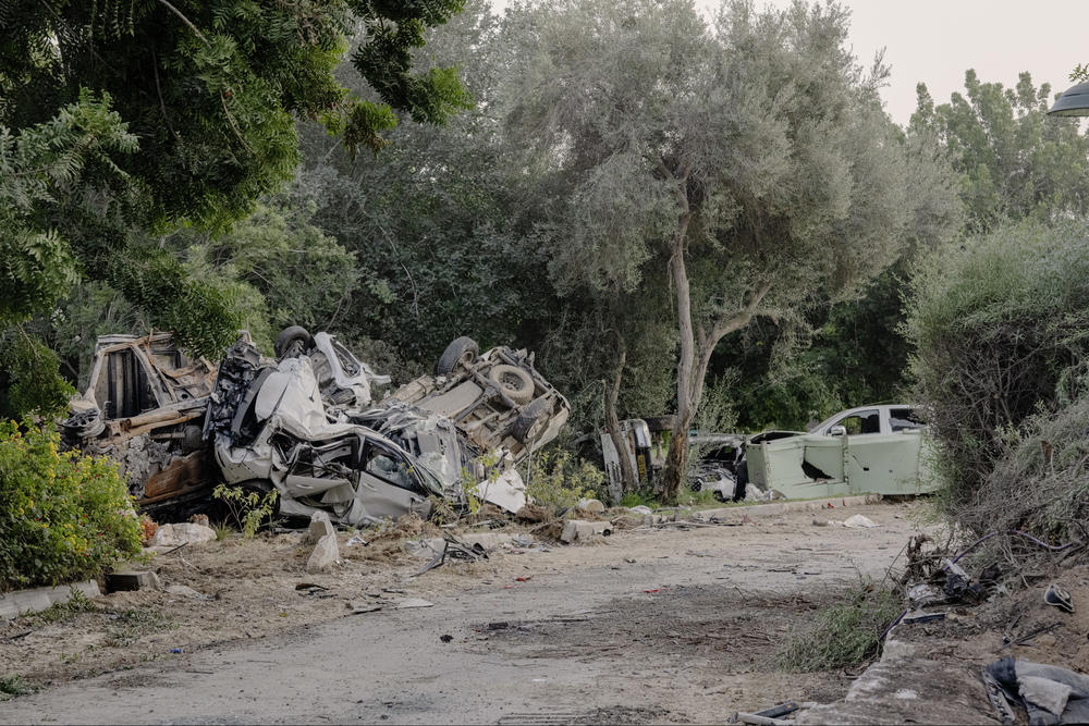 Destroyed cars, houses, and other carnage present in the Kibbutz.