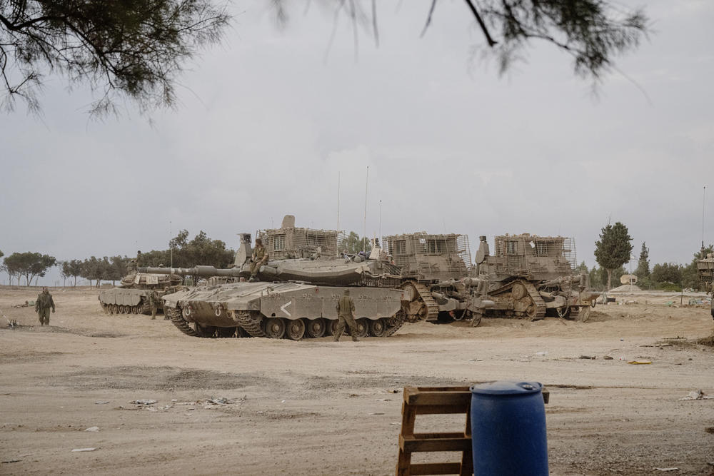 Military gathered outside of Kfar Aza kibbutz on Oct. 14, 2023.