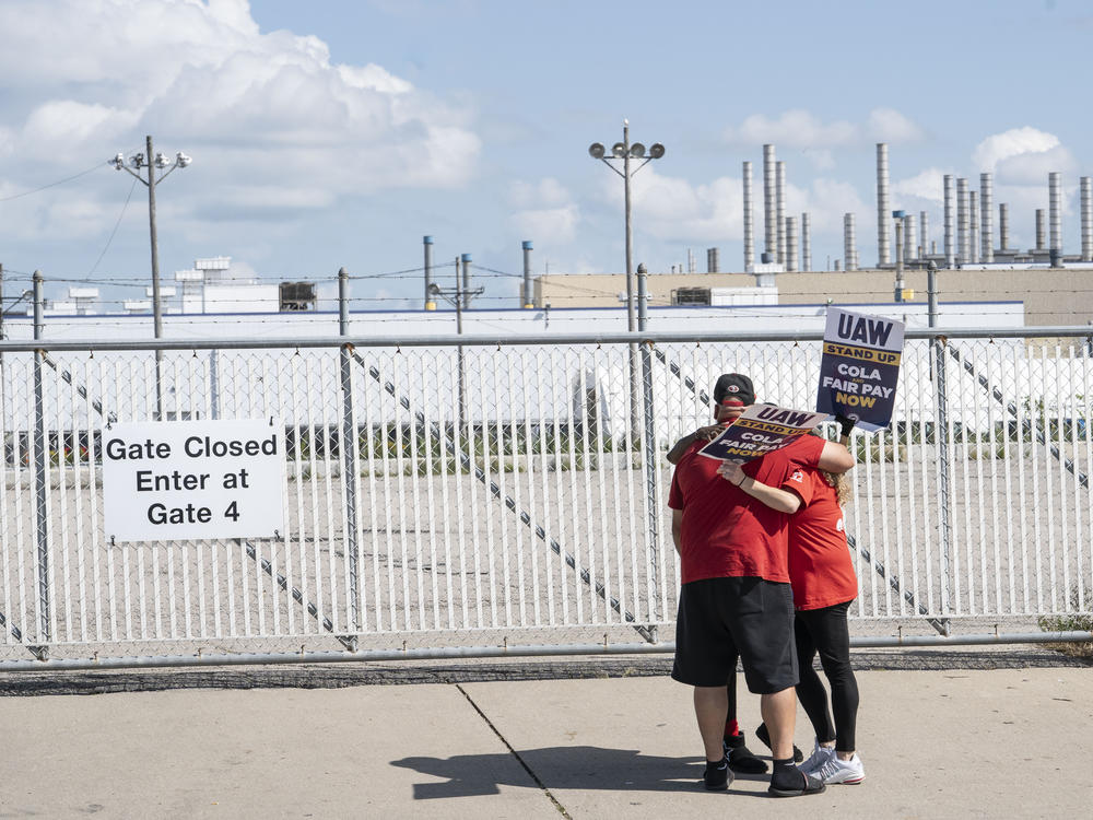 United Auto Workers members embrace outside the Jeep Plant on September 18, 2023 in Toledo, Ohio. The Big Three automakers have ramped up their offers for a new contract, but UAW President Shawn Fain  says the union needs to hold out for more.