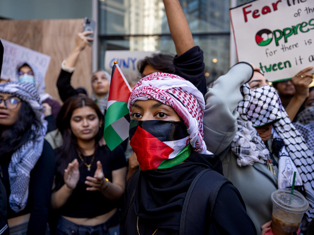 Students from Hunter College chant and hold up signs during a pro-Palestinian demonstration at the entrance of their campus in New York earlier this month.