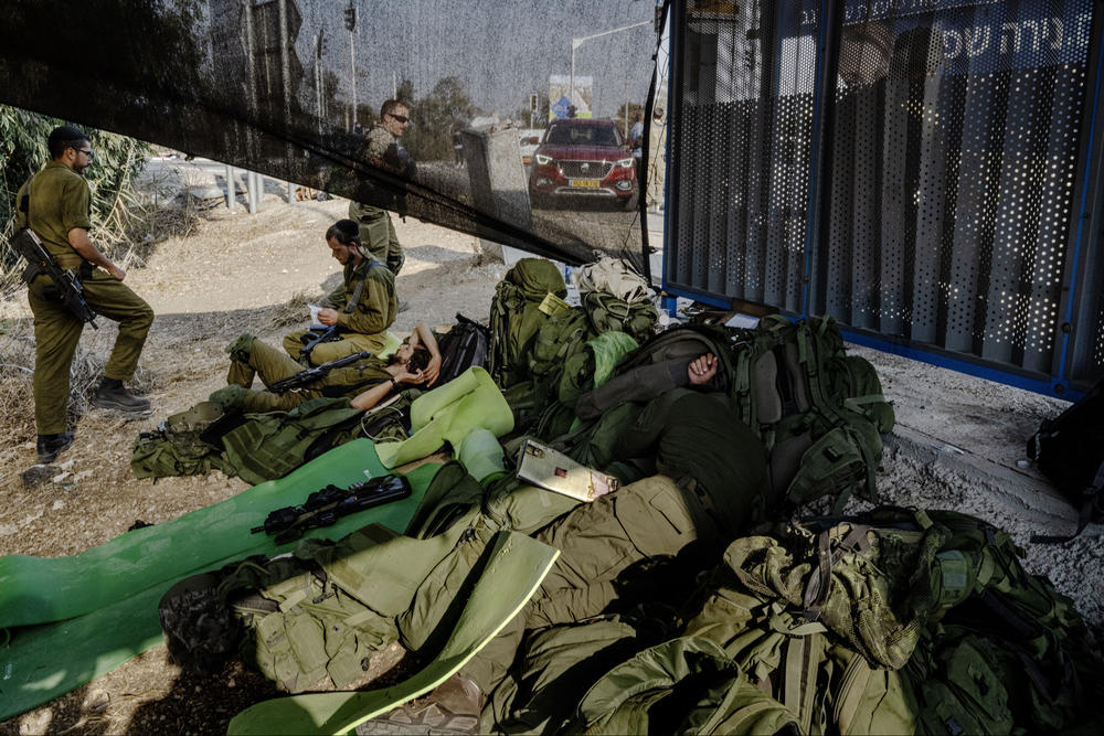 Israeli soldiers man a checkpoint outside Kfar Aza, site of the incursion by Hamas.