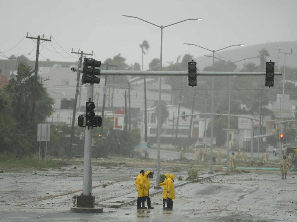 Mexican soldiers and rescue teams remove mud and sludge from a avenue flooded by the rains of Hurricane Norma in San Jose del Cabo, Mexico, on Saturday.