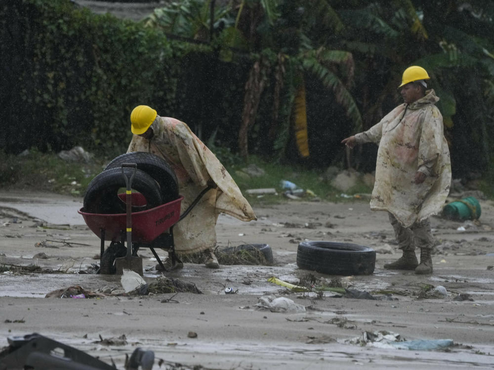 Mexican soldiers remove tires from the mud caused by hurricane Norma hit a beach in San Jose del Cabo, Mexico, on Saturday.