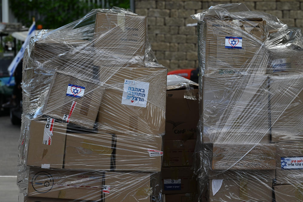 Boxes of donated supplies. The sign says, 