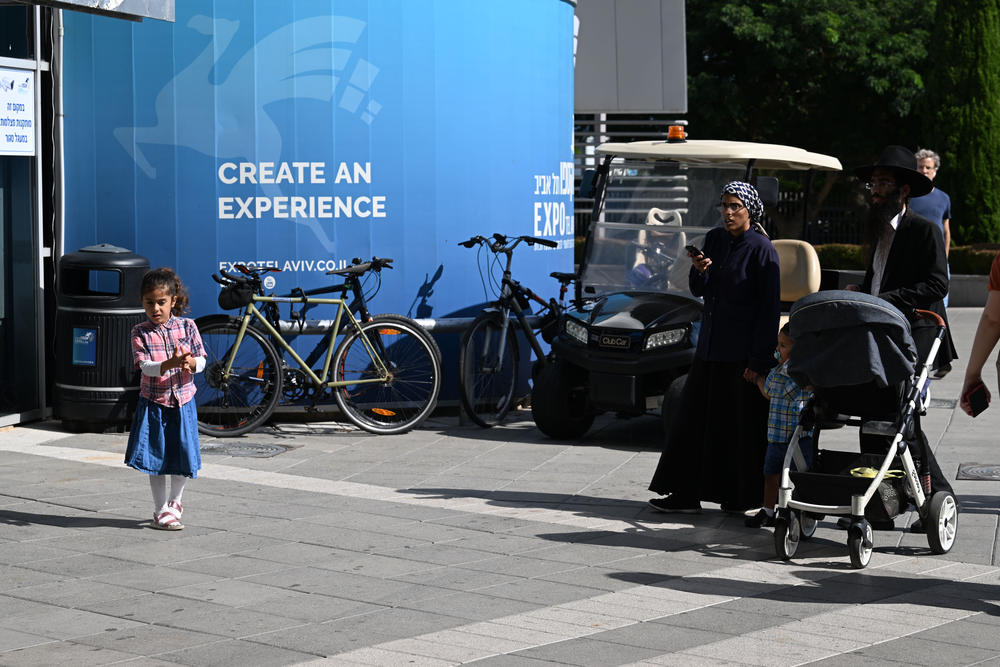 People arrive at the Expo Tel Aviv International Convention Center.