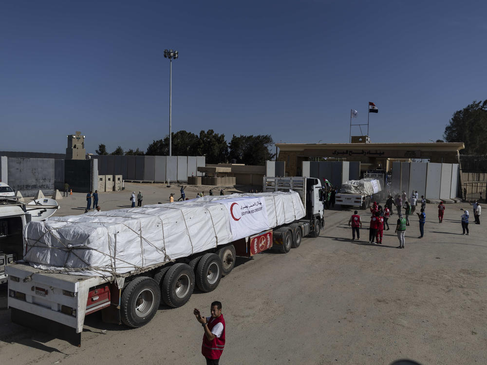 Aid convoy trucks cross the Rafah border from the Egyptian side on Saturday in North Sinai, Egypt.