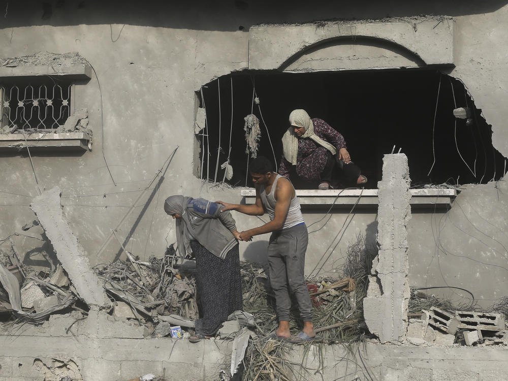 Palestinians evacuate a building damaged in the Israeli bombardment of the Gaza Strip in Rafah on Sunday.