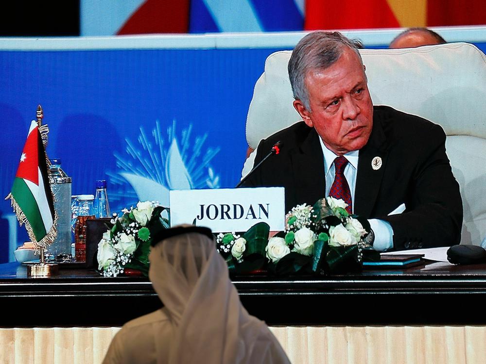 Jordan's King Abdullah is seen on a large screen at a peace summit hosted by the Egyptian president in the New Administrative Capital east of Cairo, on Saturday.