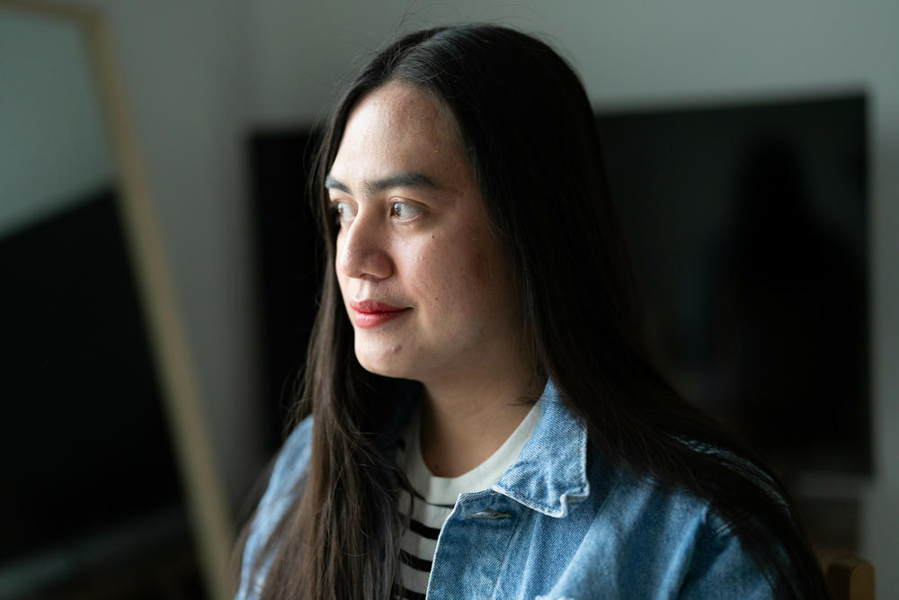 Roi Lubian poses for a portrait in her home in Bismarck, N.D. Originally from the Philippines, Lubian is working as a nurse in North Dakota. She says she moved to the United States in search of better economic opportunities.