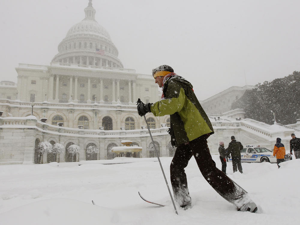 Travis Grout uses his cross country snow skis to get around the West Front of the Capitol in Washington, Feb. 6, 2010.
