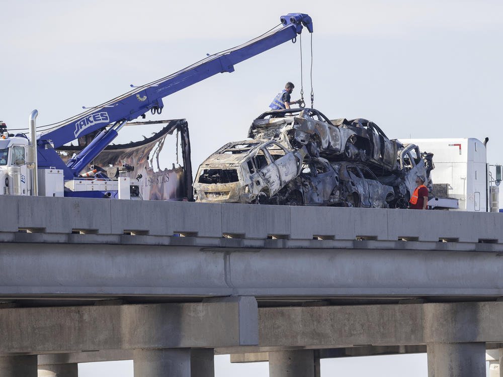 Workers remove heavily damaged vehicles from Interstate 55 near Manchac, La., on Monday.