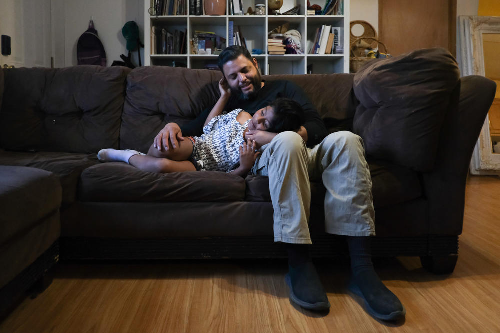 Jose Grajeda and his daughter, Victoria, cuddling before bedtime in Alpine, Tex. 