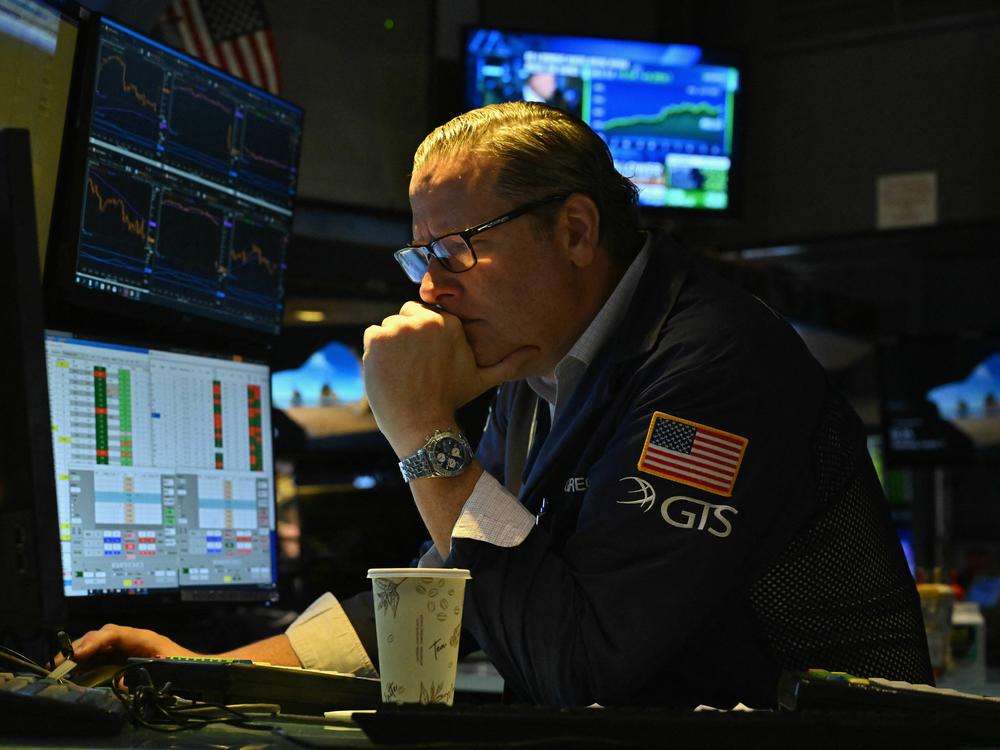 A trader works at the New York Stock Exchange on Oct. 11. Bond yields are surging, threatening to raise borrowing costs across the economy.