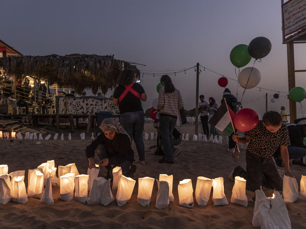 A Lebanese girl lights a candle during an event in Beirut on  Sunday honoring Issam Abdallah, a Lebanese photojournalist who had been working for Reuters. The news agency says Abdallah was killed in southern Lebanon by a missile strike from the direction of Israel on Oct. 13.