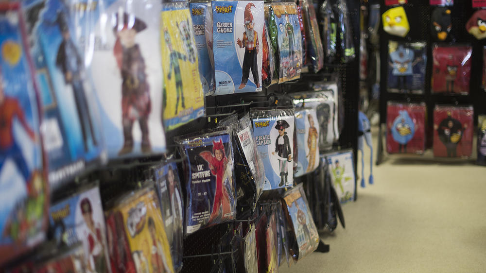 Children's Halloween costumes hang on a wall at a Spirit Halloween store. Like pumpkin patches, the seasonal pop-up shops are a signal that fall is upon us.