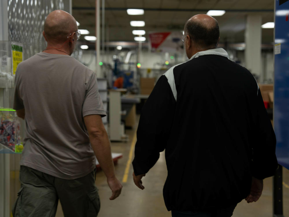 Roman (left) is a Ukrainian refugee who works at ComDel Innovation in Wahpeton, N.D. CEO Jim Albrecht (right) says the company has been working with a program called Uniting For Ukraine that provides a legal pathway for Ukrainians to come to the U.S. and work for up to two years.