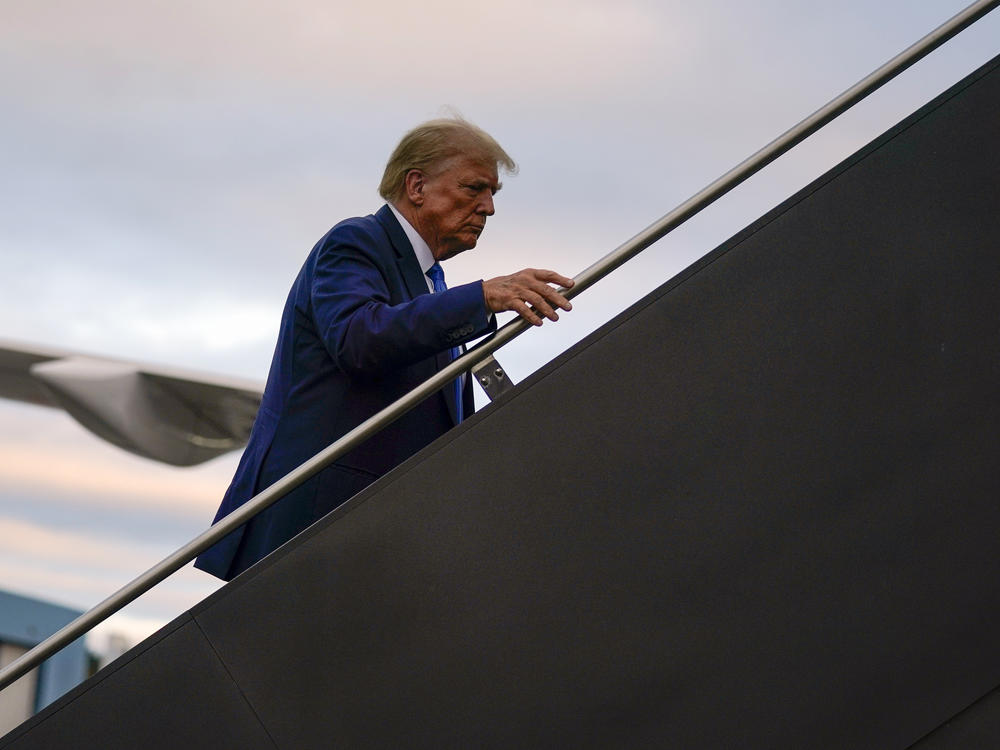 Republican presidential candidate and former President Donald Trump boards his plane at Manchester-Boston Regional Airport on Monday.
